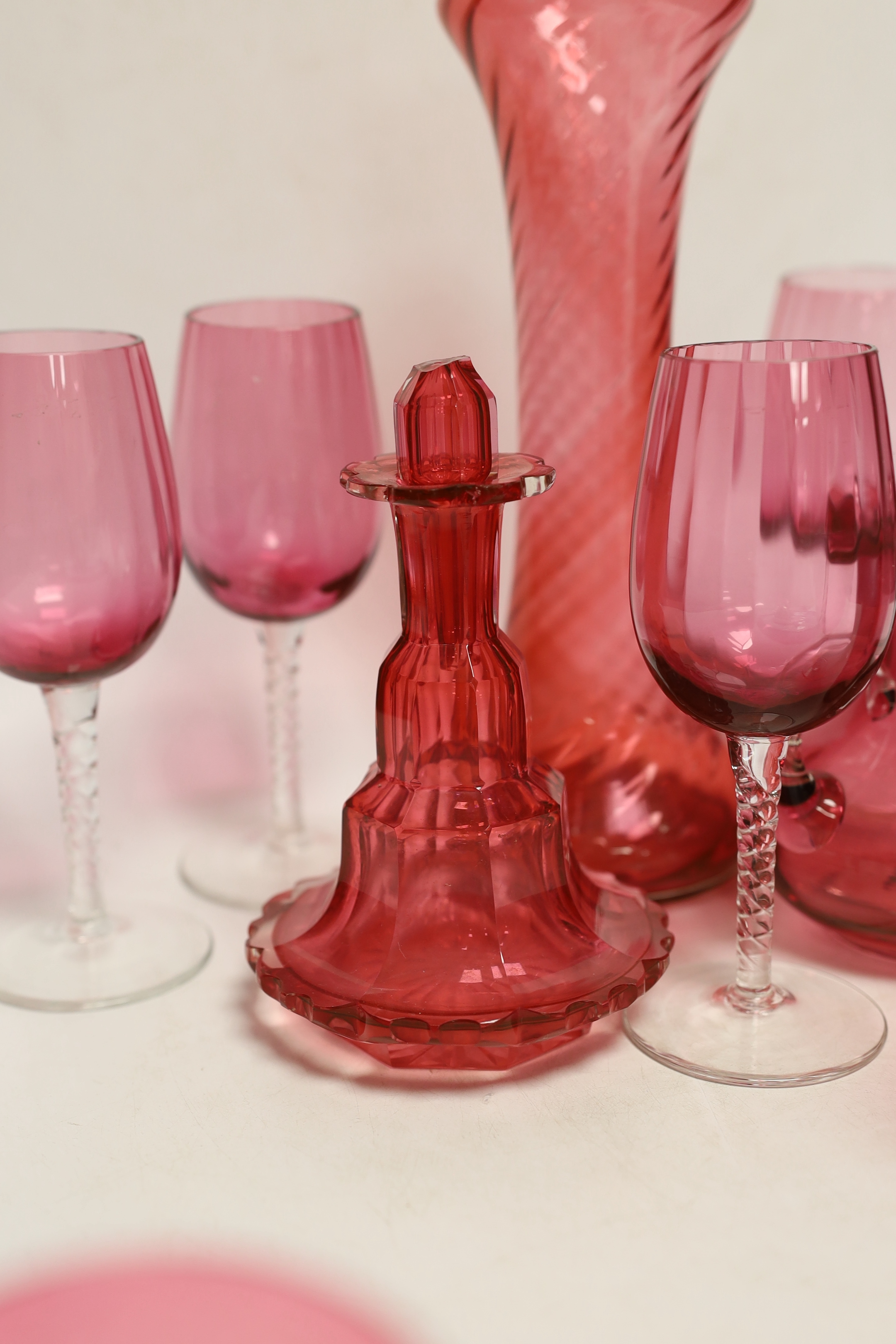 A Royal Crown Derby oval wall plate, a tortoise figure model and thirteen cranberry glass items including wine glasses, a decanter, etc. (15)